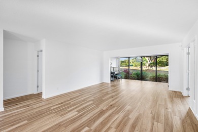 Serene golf course and pond views enhance this first-floor on Quail Ridge Golf Course and Country Club in Florida - for sale on GolfHomes.com, golf home, golf lot