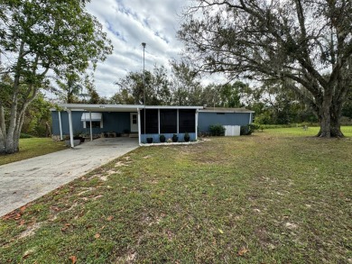 Nestled in Hidden Golf, this charming home backs up to serene on Lake Henry Golf Club in Florida - for sale on GolfHomes.com, golf home, golf lot