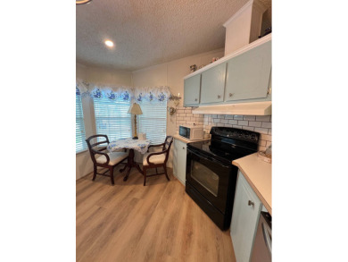 Delightful and meticulously maintained home, partially furnished on Lake Henry Golf Club in Florida - for sale on GolfHomes.com, golf home, golf lot