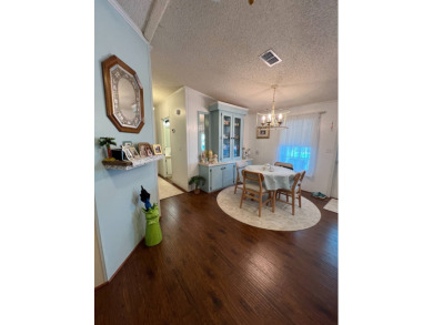 Delightful and meticulously maintained home, partially furnished on Lake Henry Golf Club in Florida - for sale on GolfHomes.com, golf home, golf lot