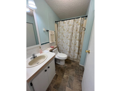 Delightful and meticulously maintained home, partially furnished on Lake Henry Golf Club in Florida - for sale on GolfHomes.com, golf home, golf lot