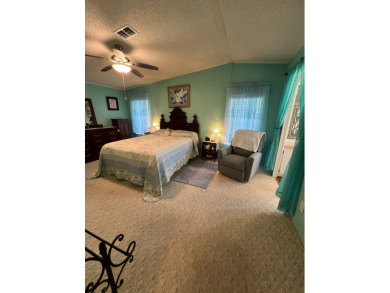 Delightful and meticulously maintained home, partially furnished on Lake Henry Golf Club in Florida - for sale on GolfHomes.com, golf home, golf lot