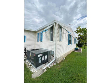 Delightful and meticulously maintained home, partially furnished on Lake Henry Golf Club in Florida - for sale on GolfHomes.com, golf home, golf lot