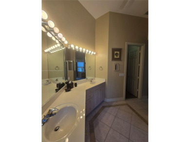 Enter through a private entrance to a peacefully courtyard with on Kensington Golf and Country Club in Florida - for sale on GolfHomes.com, golf home, golf lot