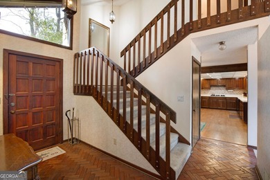 Tucked among mature trees and backing to the Rivermont golf on Rivermont Golf and Country Club in Georgia - for sale on GolfHomes.com, golf home, golf lot