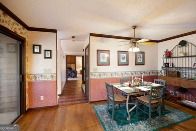 Tucked among mature trees and backing to the Rivermont golf on Rivermont Golf and Country Club in Georgia - for sale on GolfHomes.com, golf home, golf lot