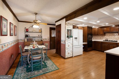 Tucked among mature trees and backing to the Rivermont golf on Rivermont Golf and Country Club in Georgia - for sale on GolfHomes.com, golf home, golf lot