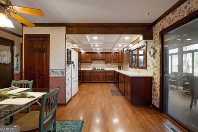 Tucked among mature trees and backing to the Rivermont golf on Rivermont Golf and Country Club in Georgia - for sale on GolfHomes.com, golf home, golf lot