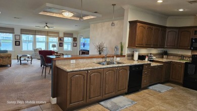 Come take a tour of this 2016 Palm Harbor Wellington Model one on The Riverside Golf Club in Florida - for sale on GolfHomes.com, golf home, golf lot