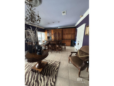Ever dream of living on Marina Road? This single-story home on Orange Beach Golf Center in Alabama - for sale on GolfHomes.com, golf home, golf lot