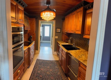 Ever dream of living on Marina Road? This single-story home on Orange Beach Golf Center in Alabama - for sale on GolfHomes.com, golf home, golf lot