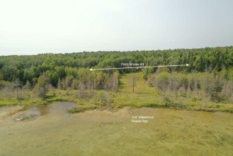 100 feet of Lake Huron waterfront on this beautiful cleared lot on Les Cheneaux Golf Club in Michigan - for sale on GolfHomes.com, golf home, golf lot