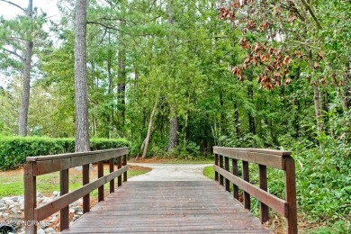 Wooded lot overlooking the 4th Fairway of the Heron course on Carolina National Golf Club in North Carolina - for sale on GolfHomes.com, golf home, golf lot