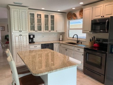 BEAUTIFULLY RENOVATED HURRICANE IMPACT WINDOWS NEW TRAVERTINE on Plantation Golf and Country Club in Florida - for sale on GolfHomes.com, golf home, golf lot