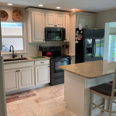 BEAUTIFULLY RENOVATED HURRICANE IMPACT WINDOWS NEW TRAVERTINE on Plantation Golf and Country Club in Florida - for sale on GolfHomes.com, golf home, golf lot