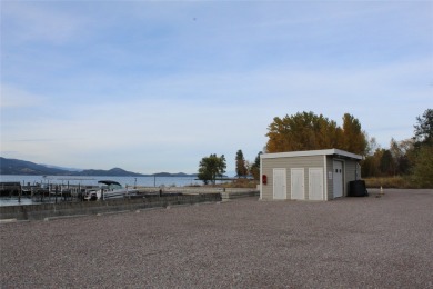 Check out this perfectly located 2 bedroom/2 bathroom unit, with on Polson Bay Golf Course - Championship Course in Montana - for sale on GolfHomes.com, golf home, golf lot