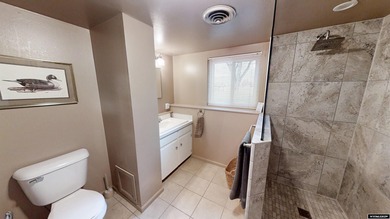 Welcome to this beautiful 3-bedroom, 2-bath tri-level located on on Paradise Valley Country Club in Wyoming - for sale on GolfHomes.com, golf home, golf lot