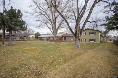 Welcome to this beautiful 3-bedroom, 2-bath tri-level located on on Paradise Valley Country Club in Wyoming - for sale on GolfHomes.com, golf home, golf lot