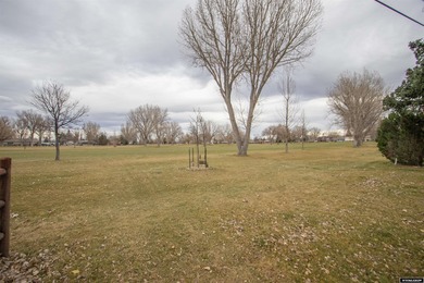 Welcome to this beautiful 3-bedroom, 2-bath tri-level located on on Paradise Valley Country Club in Wyoming - for sale on GolfHomes.com, golf home, golf lot