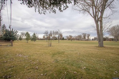 Welcome to this beautiful 3-bedroom, 2-bath tri-level located on on Paradise Valley Country Club in Wyoming - for sale on GolfHomes.com, golf home, golf lot