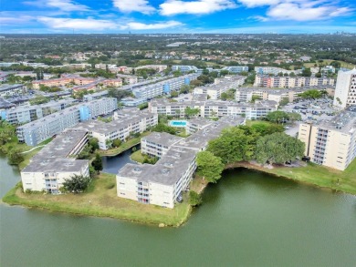 Discover the perfect first-floor corner unit with a tranquil on Presidential Estate Golf Course in Florida - for sale on GolfHomes.com, golf home, golf lot