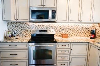 Two-bedroom, two-bath penthouse condo with extra room/office at on Isla Del Sol Yacht and Country Club in Florida - for sale on GolfHomes.com, golf home, golf lot