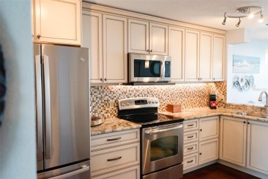 Two-bedroom, two-bath penthouse condo with extra room/office at on Isla Del Sol Yacht and Country Club in Florida - for sale on GolfHomes.com, golf home, golf lot