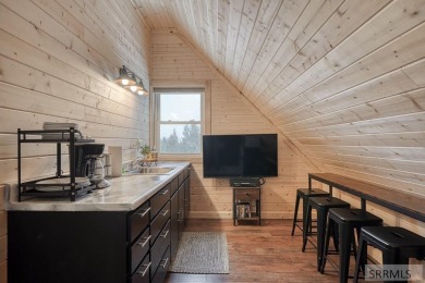 This short term rental sets in the heart of Island Park on Island Park Village Resort Golf Course in Idaho - for sale on GolfHomes.com, golf home, golf lot