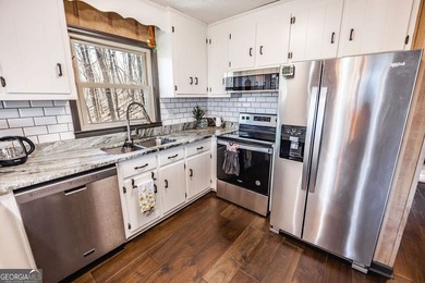 This updated 4-bedroom, 3-bath home is tucked into the Bent Tree on Bent Tree Golf Course in Georgia - for sale on GolfHomes.com, golf home, golf lot