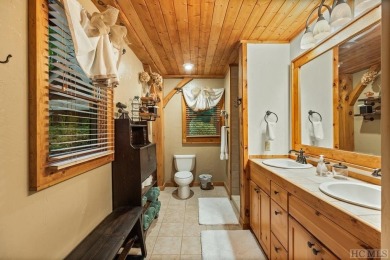 This beautiful, fully furnished, 3-bedroom, 2.5-bath wood cabin on Sapphire National Golf Club in North Carolina - for sale on GolfHomes.com, golf home, golf lot