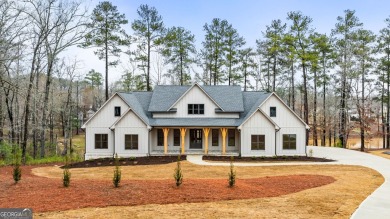 Relax and gaze upon the peaceful water view of this interior on Harbor Club Golf and Country Club in Georgia - for sale on GolfHomes.com, golf home, golf lot