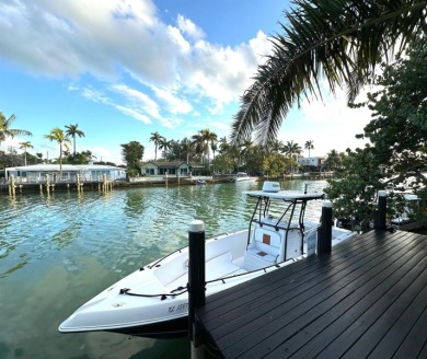 Exceptional fully renovated waterfront residence located on the on Normandy Shores Golf Course in Florida - for sale on GolfHomes.com, golf home, golf lot
