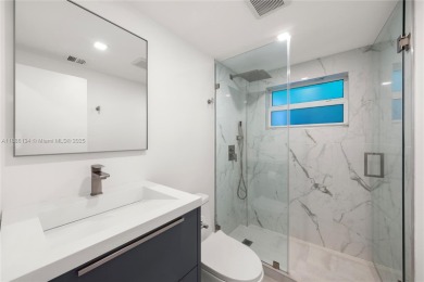 Exceptional fully renovated waterfront residence located on the on Normandy Shores Golf Course in Florida - for sale on GolfHomes.com, golf home, golf lot