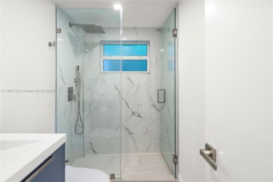 Exceptional fully renovated waterfront residence located on the on Normandy Shores Golf Course in Florida - for sale on GolfHomes.com, golf home, golf lot