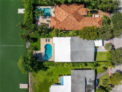 Exceptional fully renovated waterfront residence located on the on Normandy Shores Golf Course in Florida - for sale on GolfHomes.com, golf home, golf lot