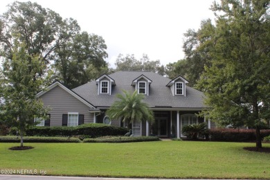 This elegant southern-style pool home in  prestigious Queens on Queens Harbour Yacht and Country Club in Florida - for sale on GolfHomes.com, golf home, golf lot