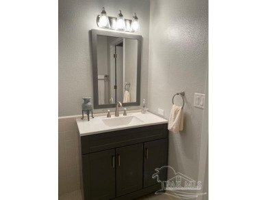 This beautifully furnished, wheelchair-accessible corner unit on on Pensacola Country Club in Florida - for sale on GolfHomes.com, golf home, golf lot