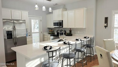 From the moment you step inside this sun-filled end-unit on Belvedere Country Club in North Carolina - for sale on GolfHomes.com, golf home, golf lot