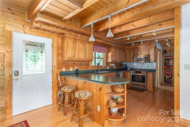 NO DAMAGE FROM HELENE-HIGH  DRY. This warm and inviting log home on Waynesville Country Club Inn in North Carolina - for sale on GolfHomes.com, golf home, golf lot