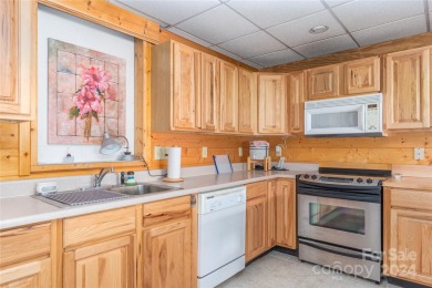 NO DAMAGE FROM HELENE-HIGH  DRY. This warm and inviting log home on Waynesville Country Club Inn in North Carolina - for sale on GolfHomes.com, golf home, golf lot