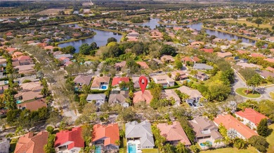 Discover this stunning one-story estate in Weston Hills on Weston Hills Country Club in Florida - for sale on GolfHomes.com, golf home, golf lot