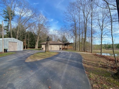 Set on a beautiful wooded 8+ acre lot this nicely updated 5 on Pine River Golf Club in Michigan - for sale on GolfHomes.com, golf home, golf lot