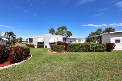 Under contract-accepting backup offers. The curb appeal of this on Maple Leaf Golf and Country Club in Florida - for sale on GolfHomes.com, golf home, golf lot