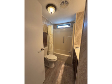 This great manufactured home on leased land is located in Lake on Pine Lakes Country Club in Florida - for sale on GolfHomes.com, golf home, golf lot
