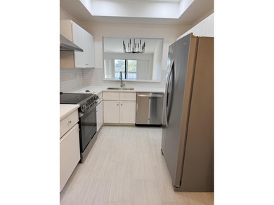 UPDATED 2ND FLOOR CONDO FEATURING WHITE EAT-IN KITCHEN WITH NEW on Boca Delray Golf and Country Club in Florida - for sale on GolfHomes.com, golf home, golf lot