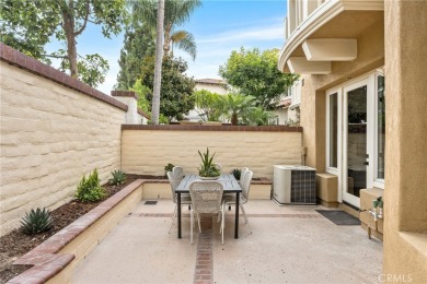Nestled in a secure gated community within walking distance to on Tustin Ranch Golf Club in California - for sale on GolfHomes.com, golf home, golf lot