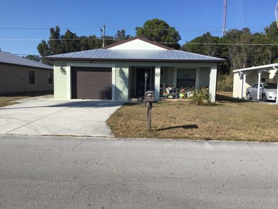 Move right into this concrete block home that backs up to the on Spanish Lakes I in Florida - for sale on GolfHomes.com, golf home, golf lot