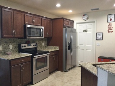 Move right into this concrete block home that backs up to the on Spanish Lakes I in Florida - for sale on GolfHomes.com, golf home, golf lot