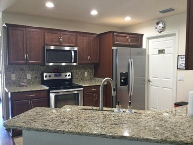 Move right into this concrete block home that backs up to the on Spanish Lakes I in Florida - for sale on GolfHomes.com, golf home, golf lot