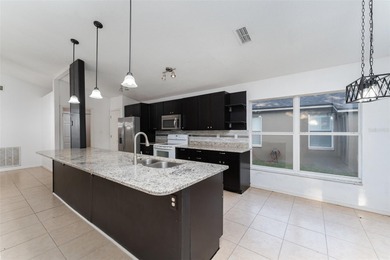 Welcome to the perfect Florida retreat where lush green fairways on Oakwood Golf Club in Florida - for sale on GolfHomes.com, golf home, golf lot